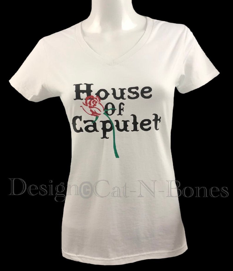 May include: White t-shirt with a black graphic that says "House of Capulet" with a red rose and green stem.
