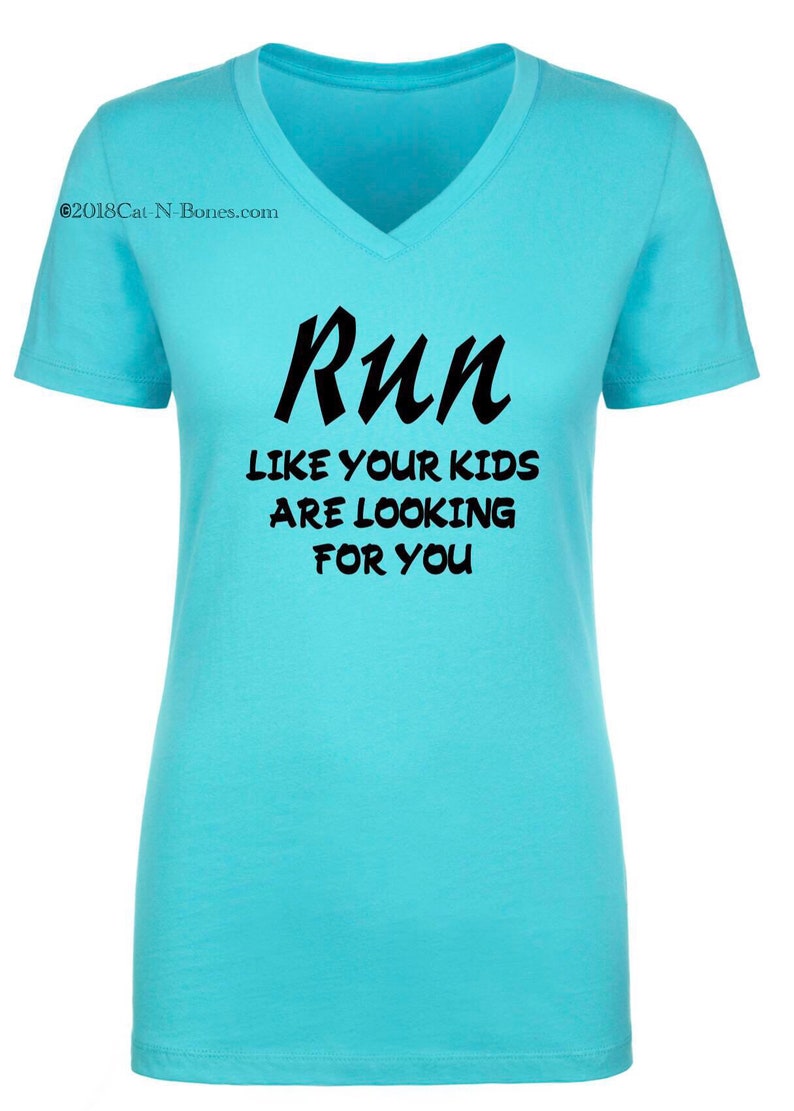 May include: A turquoise blue v-neck t-shirt with the text "Run like your kids are looking for you" printed in black.