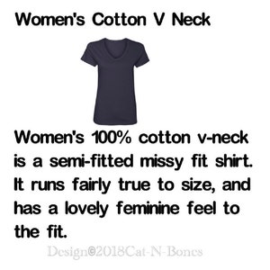 May include: A navy blue v-neck t-shirt made of 100% cotton. The shirt is semi-fitted and has a missy fit. It runs true to size and has a feminine feel. "Women's Cotton V Neck" and "Design 2018Cat-N-Bones" are printed on the image.