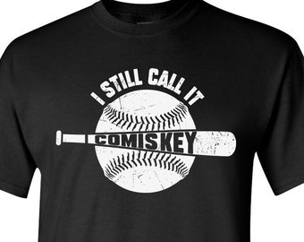 May include: Black t-shirt with a white graphic of a baseball and bat with the text "I Still Call It Comiskey".