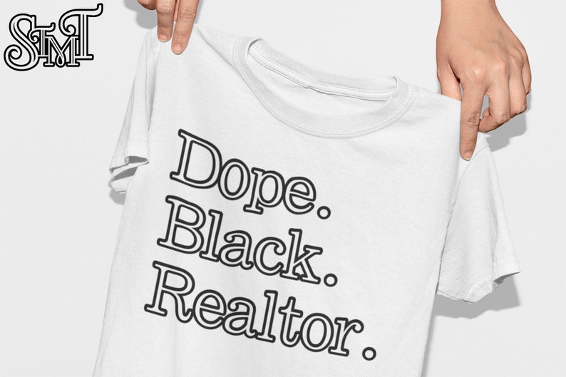 May include: White t-shirt with the text "Dope. Black. Realtor." in a bold, black font. The shirt is held up by a person's hands, showcasing the design. The upper left corner features a stylized logo.