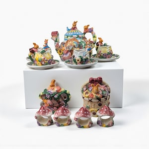 May include: A set of three ceramic mugs with a speckled, matte finish. The mugs are in shades of cream, light gray, and dark gray. Each mug has a simple, minimalist design, perfect for coffee or tea.