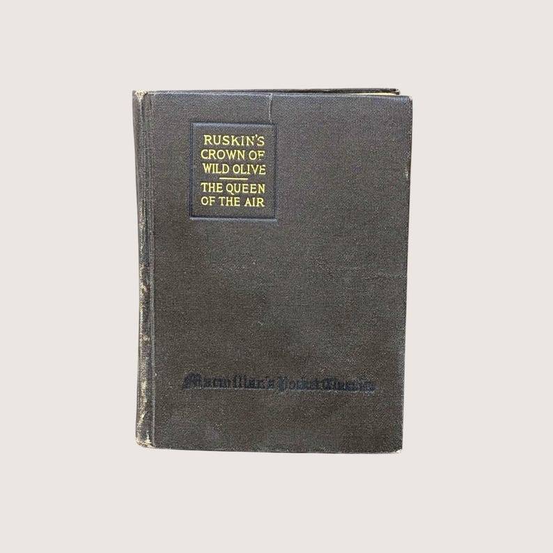 A 1915 hardcover book titled The Pentecost of Calamity by Owen Wister with a mauve textured cover and a cream-colored paper title label