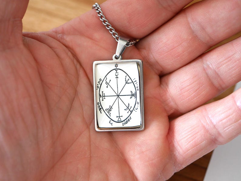 May include: A white ceramic mug with a black handle and the text "But First, Coffee" in a black, handwritten-style font. The mug is on a white surface.