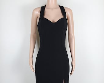 May include: A black halter-style maxi dress with a sweetheart neckline and a thigh-high slit.