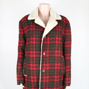 May include: A red and green plaid jacket with a white faux fur collar. The jacket has a button closure and two pockets.
