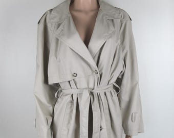 May include: A beige trench coat with a double breasted closure, a belt, and long sleeves.