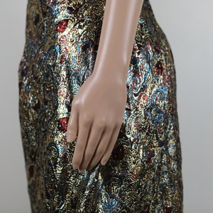 May include: A gold, blue, and red brocade skirt with a paisley pattern.