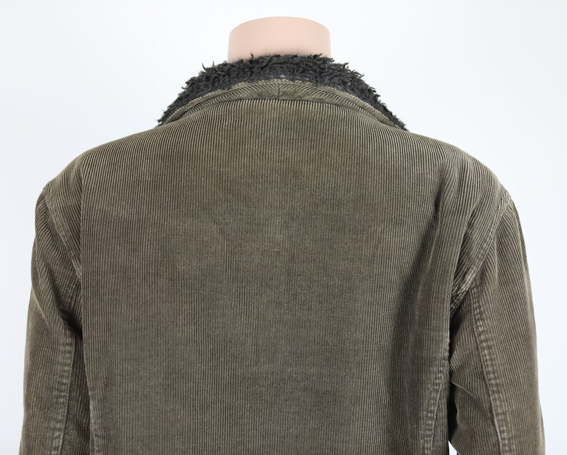 May include: A brown corduroy jacket with a black faux fur collar.