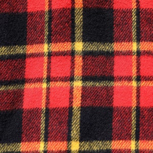 May include: Red, black and yellow plaid fabric with a woven texture.