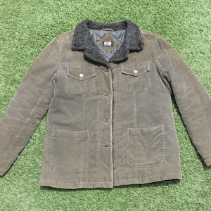 May include: A brown corduroy jacket with a faux fur collar and two large pockets. The jacket has a button closure and a quilted lining.