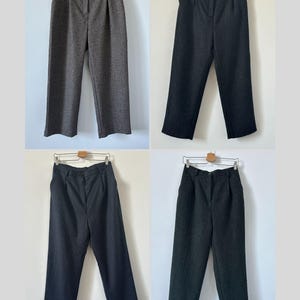 May include: Four pairs of wide-leg pants in different shades of gray. The pants have a high waist and a straight leg.