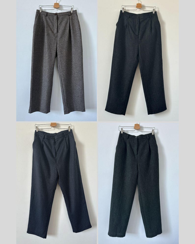 May include: Four pairs of wide-leg pants in different shades of gray. The pants have a high waist and a straight leg.