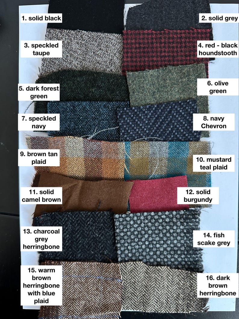 May include: A swatch card with 16 different fabric samples. The samples are arranged in two columns of eight. Each sample is labeled with a number and a description of the fabric. The fabrics include solid black, solid grey, speckled taupe, red-black houndstooth, dark forest green, olive green, speckled navy, navy chevron, brown tan plaid, mustard teal plaid, solid camel brown, solid burgundy, charcoal grey herringbone, fish scale grey, warm brown herringbone with blue plaid, and dark brown herringbone.