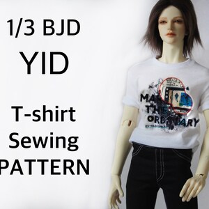 May include: A white t-shirt with a graphic design and the words "MAKE THE ORDINARY EXTRAORDINARY" is worn by a doll. The doll is wearing black pants. Text on the left side of the image reads "1/3 BJD YID T-shirt Sewing PATTERN."