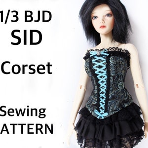 May include: A doll in a black and teal paisley corset, laced with light blue ribbon, and a black ruffled skirt with lace trim. The image includes text: 1/3 BJD SID Corset Sewing Pattern.