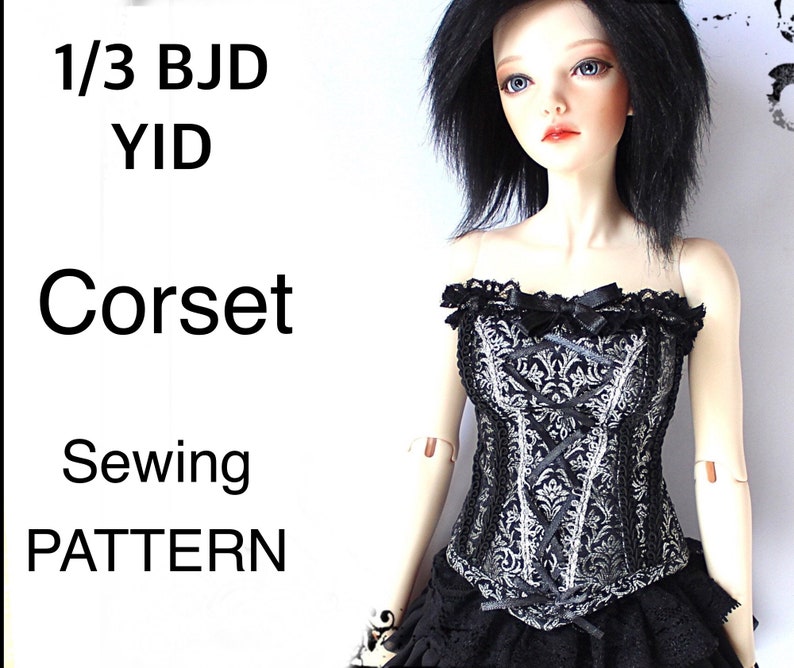 May include: A black and silver corset with a floral pattern, lace trim, and ribbon detailing. The corset is part of a sewing pattern for a 1/3 BJD YID doll. The text "Corset Sewing Pattern" is visible.