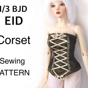 May include: A black and gold corset with white lacing, designed for a 1/3 BJD EID doll. The corset features a lace-like pattern and is a sewing pattern. The text "1/3 BJD EID Corset Sewing PATTERN" is visible.