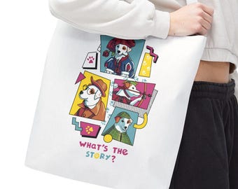 May include: White tote bag featuring a colorful graphic of cartoon dogs in various outfits. The phrase "WHAT'S THE STORY?" is printed in a playful font. The bag is carried over the shoulder.