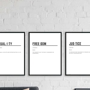 May include: Three black framed prints with white backgrounds and black text. The prints define the words "EQUALITY", "FREEDOM", and "JUSTICE" with their definitions.