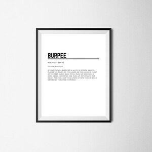 May include: A black and white printable poster with the word "Burpee" in bold text and a definition of the exercise. The poster is framed in a black frame.