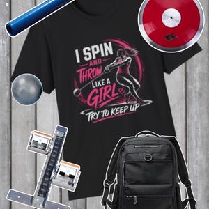 May include: A black t-shirt with a graphic of a person throwing a hammer, text reading I SPIN AND THROW LIKE A GIRL TRY TO KEEP UP, a blue relay baton, a red discus, a grey shot put, a metal measuring tool, and a black backpack with multiple pockets.