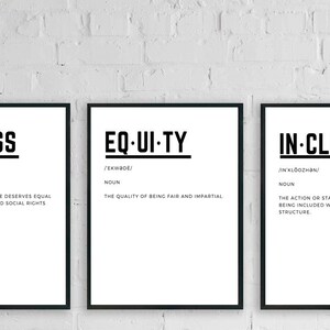 May include: Three black framed prints with white backgrounds and black text. The first print says "AC-CESS" and defines it as "the view that everyone deserves equal economic, political and social rights and opportunities". The second print says "EQ-UI-TY" and defines it as "the quality of being fair and impartial". The third print says "IN-CLU-SION" and defines it as "the action or state of including or of being included within a group or structure".