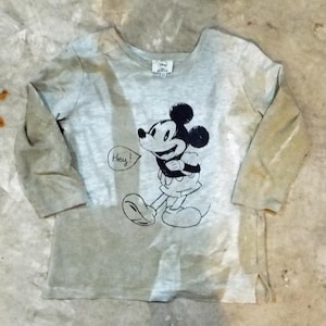 May include: A light grey long-sleeved top with a black and white Mickey Mouse graphic and the word "Hey!" in a speech bubble. The top has a crew neck and a small tag at the neckline.