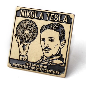 May include: A square, gold-colored pin featuring a portrait of Nikola Tesla and an illustration of a Tesla coil. The pin has black text that reads "NIKOLA TESLA" and "THE MAN WHO INVENTED THE 20TH CENTURY".