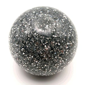 May include: A spherical decorative object with a dark gray base color and a glittery, reflective surface. The glitter appears to be silver and is evenly distributed across the surface of the sphere. The object is set against a white background.