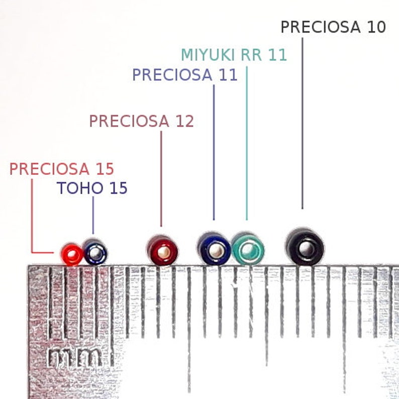 May include: A collection of colorful seed beads, including red, blue, green, and black, are displayed next to a metric ruler. The beads are labeled with brand names and sizes, such as Preciosa and Miyuki.