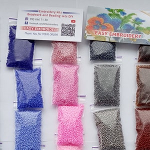 May include: A collection of small, colorful beads in clear plastic bags, arranged in rows. The beads come in various colors, including red, yellow, blue, pink, and white. A business card with the text "Easy Embroidery" is also visible.