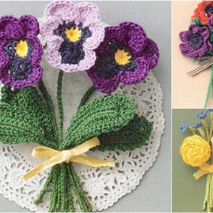 May include: A bouquet of crocheted purple, pink, and yellow flowers with green leaves. The flowers are tied together with a yellow ribbon and are sitting on a white crocheted doily.