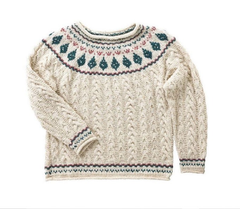 May include: A cream-colored knitted sweater with a dark green, red, and white patterned yoke. The sweater has a cable knit design and a ribbed hem and cuffs.