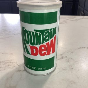 Vintage Sealed Mountain Dew Can Bank with T-Shirt