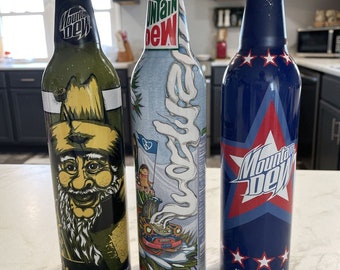 3 latas de refresco de aluminio Mountain Dew, gráficos pintados, nuevas estrellas selladas