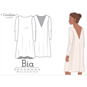 Puede incluir: Un vestido blanco con un profundo escote en V y mangas largas. El vestido tiene un corte holgado y llega hasta la rodilla. El vestido se muestra en una modelo con cabello castaño sobre un fondo neutro.