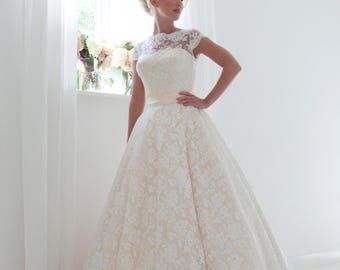 Sarah Long is a full length ballgown in apricot with cap sleeves overlayed in ivory lace