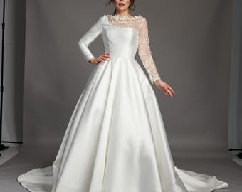 Josette is a Contemporary asymmetric mikado ballgown wedding dress with lace illusion sleeve.