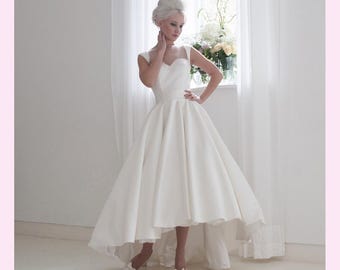 Tessa is a high low satin dress  with an illusion neckline and cap sleeves in Ivory