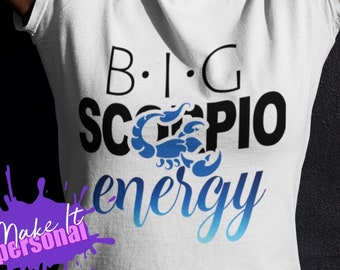May include: White t-shirt with black text that reads "B.I.G. SCORPIO energy" with a blue scorpion graphic.