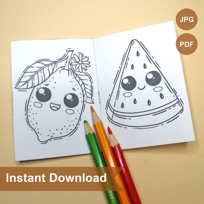 May include: A black and white coloring book with two pages showing a lemon and a watermelon with cute faces. The book is open and there are three colored pencils on top of it.