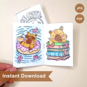 May include: A small, open book with cartoon illustrations of a bear. One bear is in a pool with a donut float, and the other is on a stack of books. The cover reads "BE CAPPY". The words "Instant Download" are at the bottom.