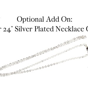 May include: A silver-plated necklace chain, available in 18-inch or 24-inch lengths, is displayed against a white background. The text "Optional Add On: 18" or 24" Silver Plated Necklace Chain" is visible.