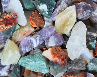 May include: A collection of various colored and textured gemstones, including amethyst, agate, and jasper.