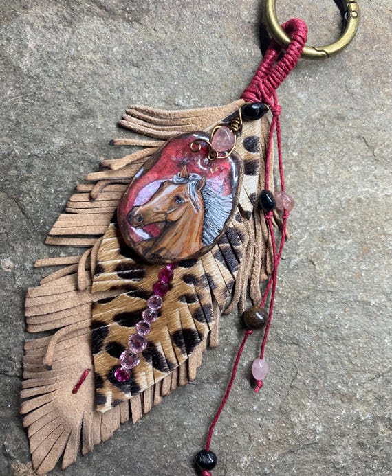 Resin Art with leather embellished feathers charm.