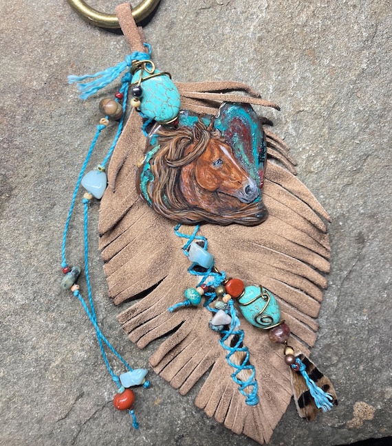 Resin Art with leather embellished feathers charm.