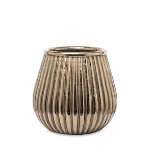 May include: A metallic bronze-toned glass vessel with a rounded, bulbous shape and a vertical ribbed texture. The surface features a reflective, slightly distressed finish with a smooth, circular rim at the top and a tapered base.