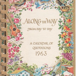May include: Vintage 1963 calendar titled "Along the Way From Day to Day." The cover features a floral border with birds, a guitar, and a small house. The calendar is bound with a spiral binding and has a gold-colored border.