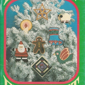 May include: A book cover with the words "HOLIDAY FELTCRAFT" in a festive font. The cover features a Christmas tree adorned with felt ornaments, including a star, sheep, candle, gingerbread man, stocking, bird, Santa, and a square design.